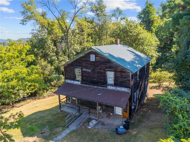 a backyard of a house with plants and wooden fence