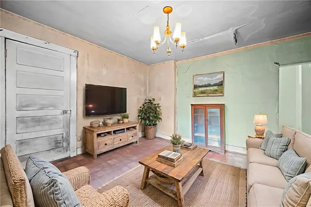 a living room with furniture a flat screen tv and a window