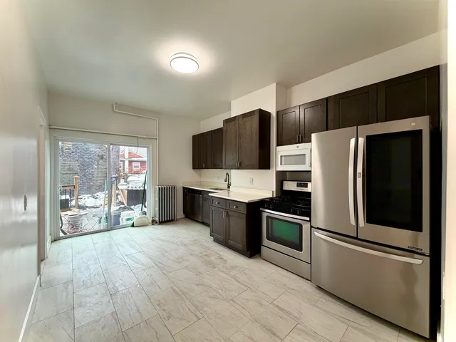 a kitchen with stainless steel appliances a refrigerator and a stove top oven