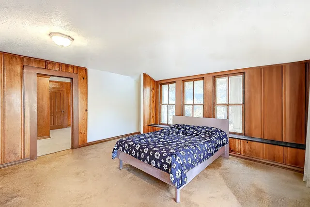 a bedroom with a bed and a window