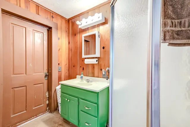 a bathroom with a sink vanity and a mirror