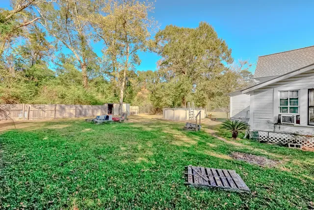 a backyard of a house with table and chairs