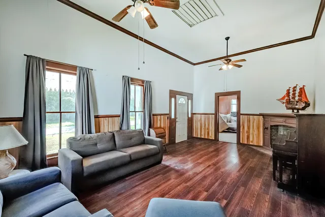 a living room with furniture and a wooden floor