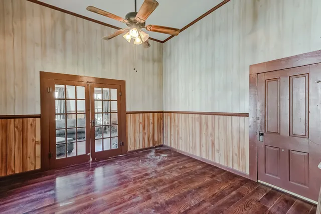 a view of a hallway with wooden floor and staircase