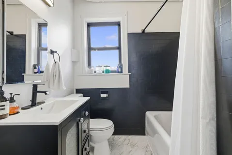 a bathroom with a sink toilet and mirror