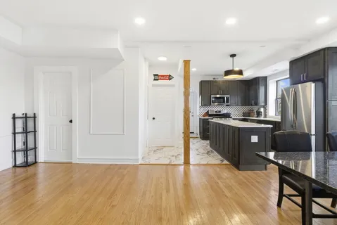 a kitchen with stainless steel appliances a refrigerator and a stove top oven