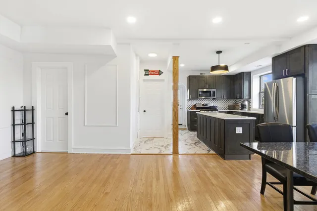 a kitchen with stainless steel appliances a refrigerator and a stove top oven