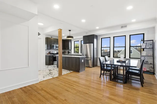 a view of a dining room with furniture window and wooden floor