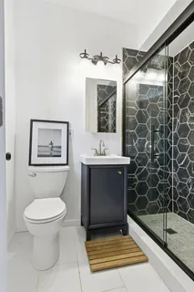 a bathroom with a toilet sink and shower