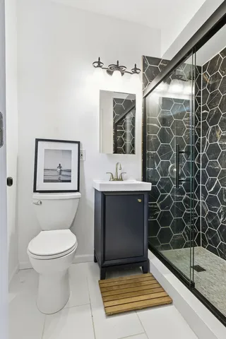 a bathroom with a toilet sink and shower