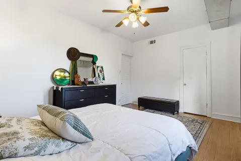 a bedroom with a bed and ceiling fan