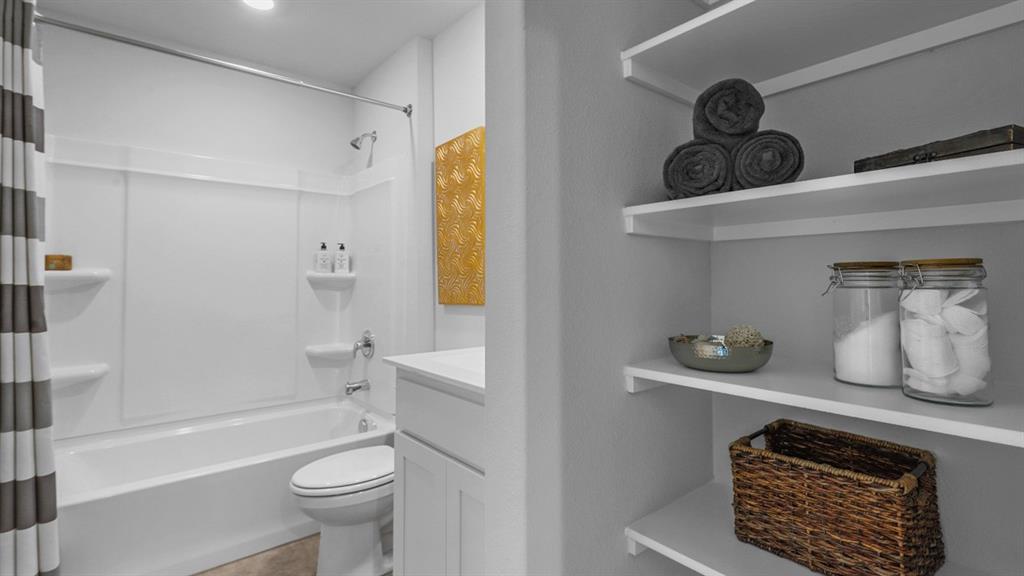 1617 Marsh Street Cleburne, TX 76033 - Photo 26 of 36 a bathroom with a sink a toilet and shower