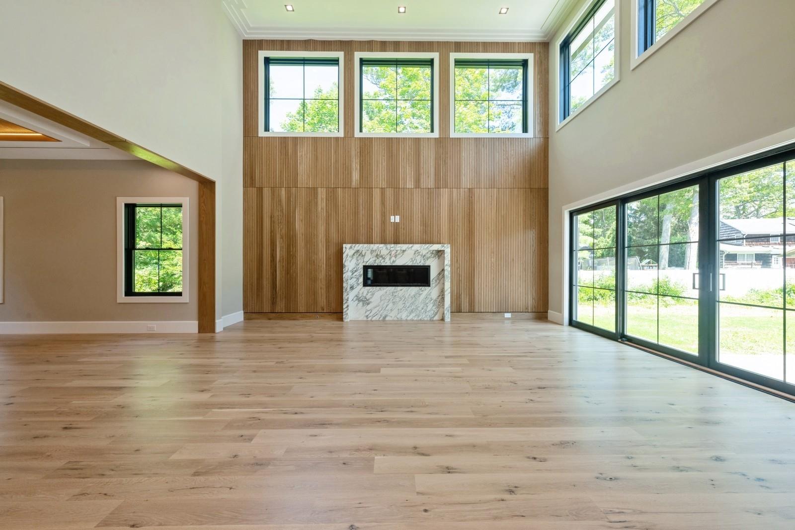 352 Cold Spring Road Syosset, NY 11791 - Photo 12 of 39 a view of an empty room with a window and a fireplace