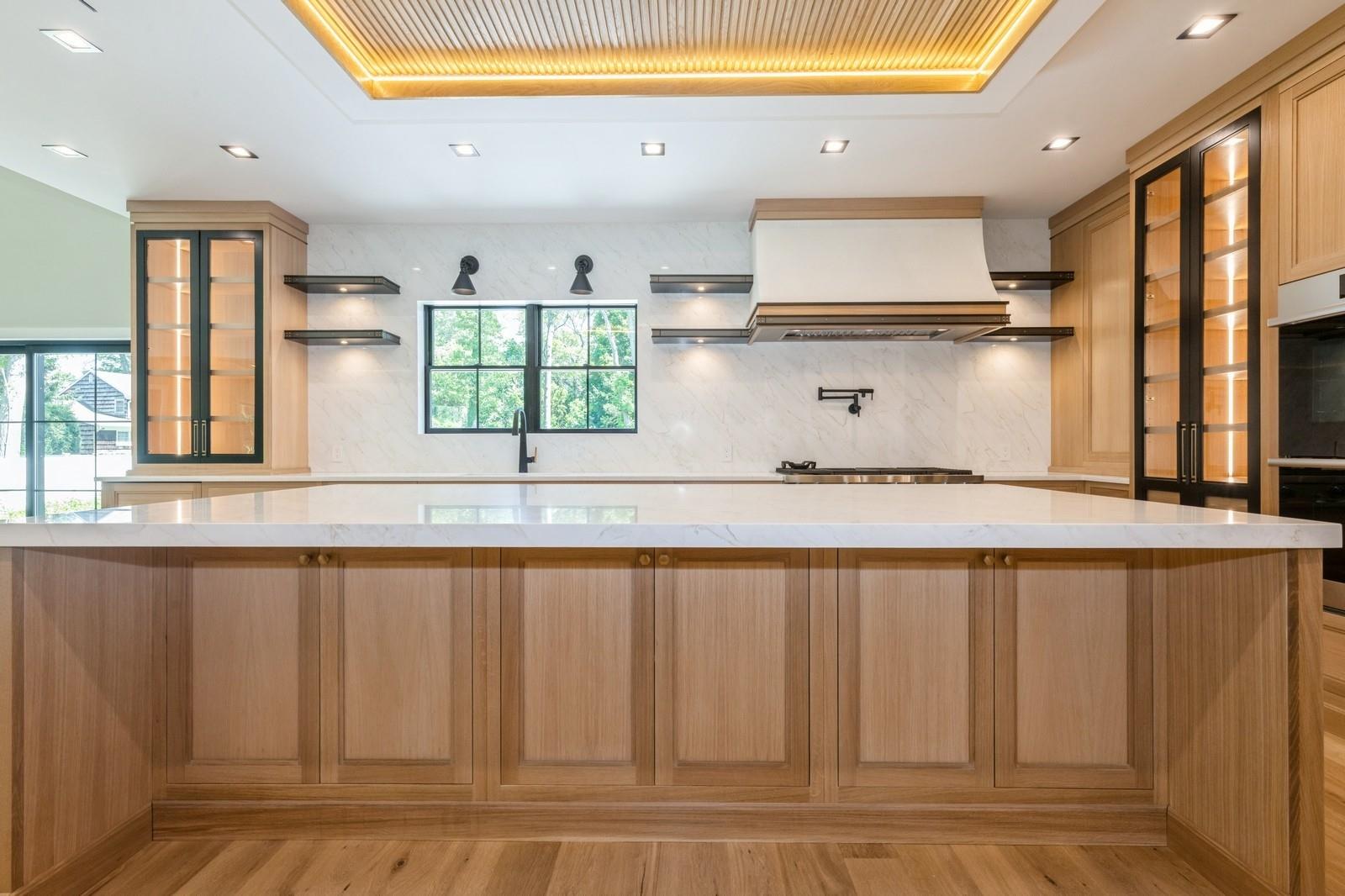 352 Cold Spring Road Syosset, NY 11791 - Photo 18 of 39 a kitchen with stainless steel appliances granite countertop a sink window and cabinets