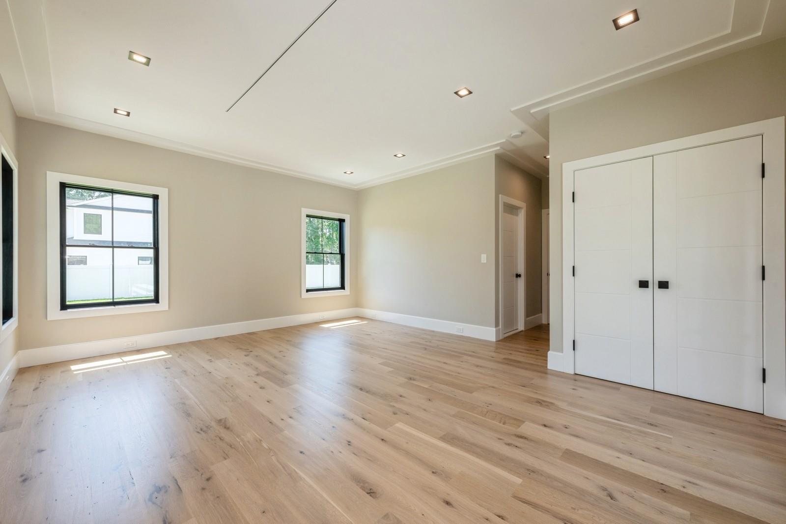 352 Cold Spring Road Syosset, NY 11791 - Photo 20 of 39 an empty room with wooden floor and windows