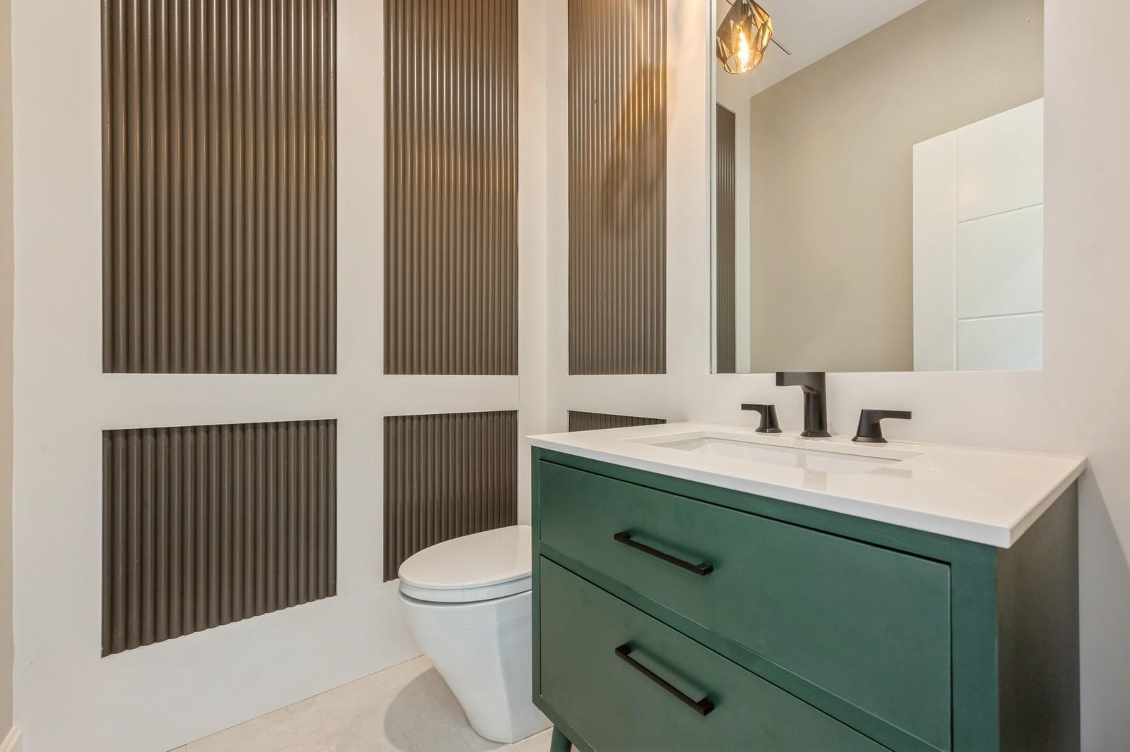 352 Cold Spring Road Syosset, NY 11791 - Photo 23 of 39 a bathroom with a sink and a mirror