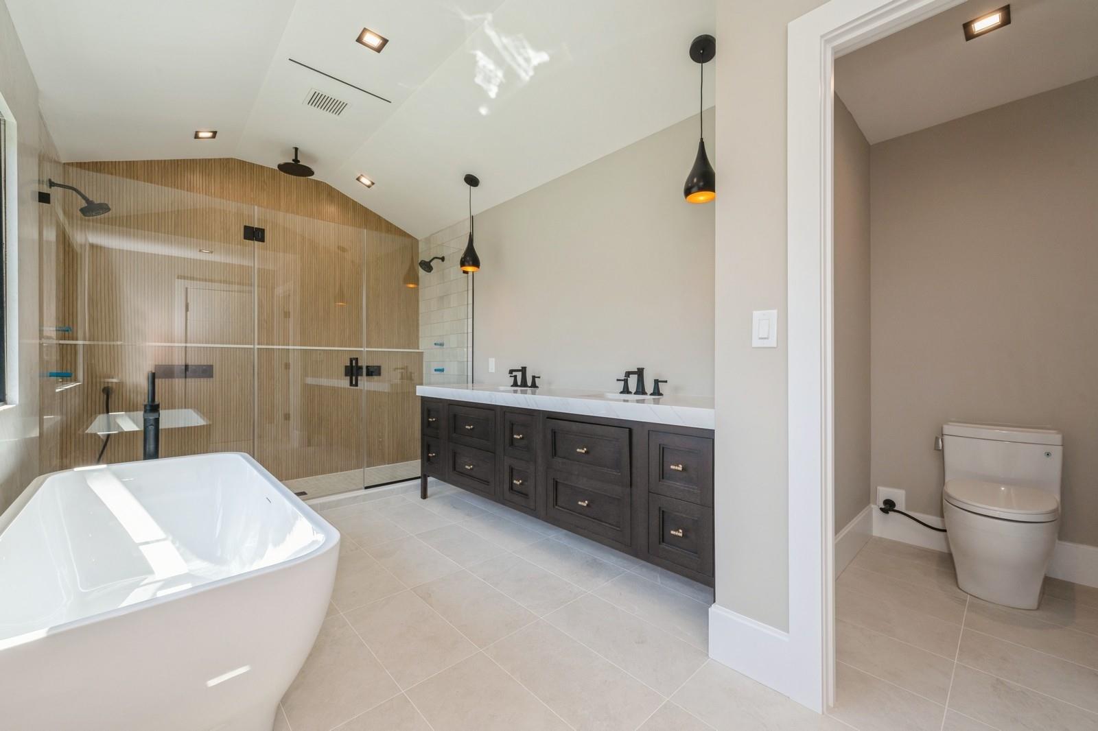 352 Cold Spring Road Syosset, NY 11791 - Photo 28 of 39 a spacious bathroom with a tub sink shower and mirror