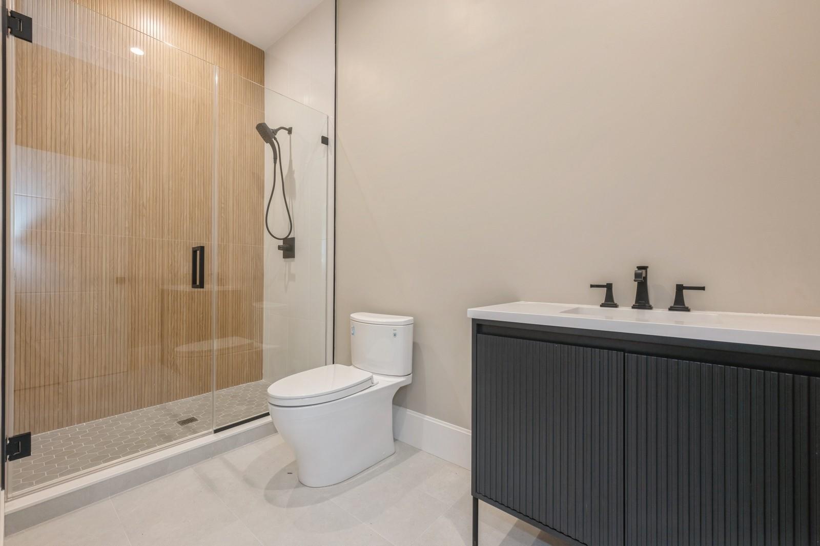 352 Cold Spring Road Syosset, NY 11791 - Photo 32 of 39 a bathroom with a sink a toilet and shower