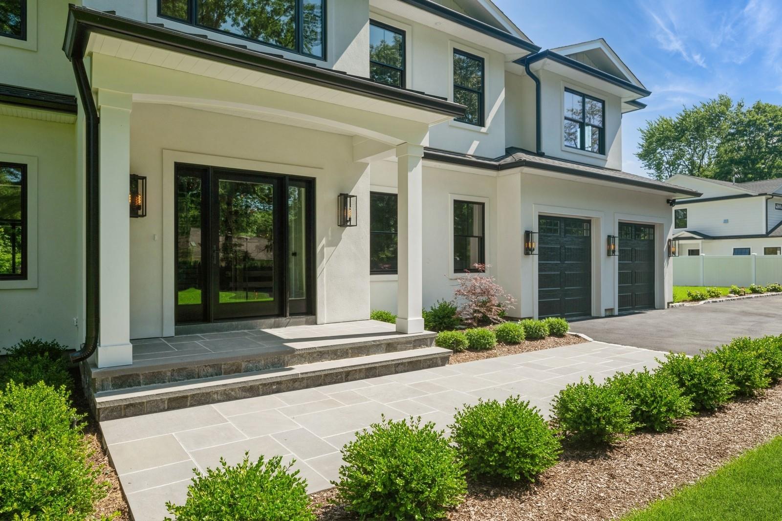 352 Cold Spring Road Syosset, NY 11791 - Photo 5 of 39 a front view of a house with a yard and garage