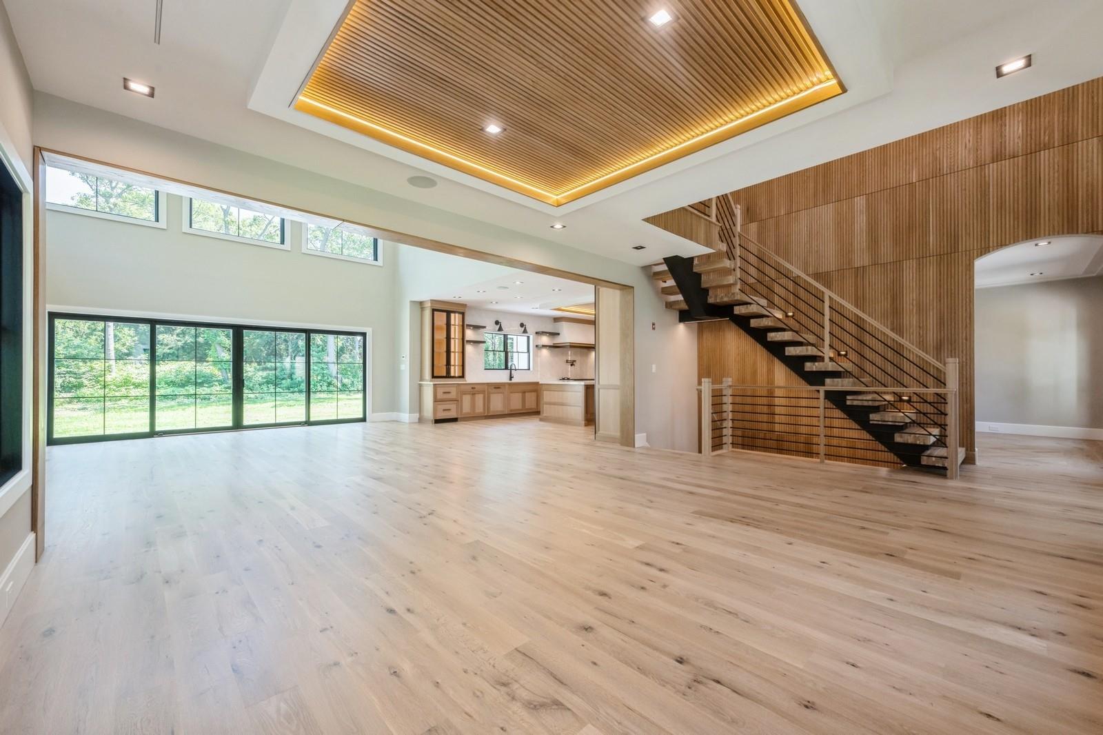 352 Cold Spring Road Syosset, NY 11791 - Photo 8 of 39 a view of an empty room with wooden floor and a window