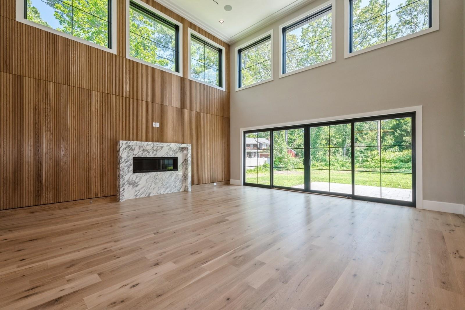 352 Cold Spring Road Syosset, NY 11791 - Photo 9 of 39 a view of an empty room with wooden floor and a window