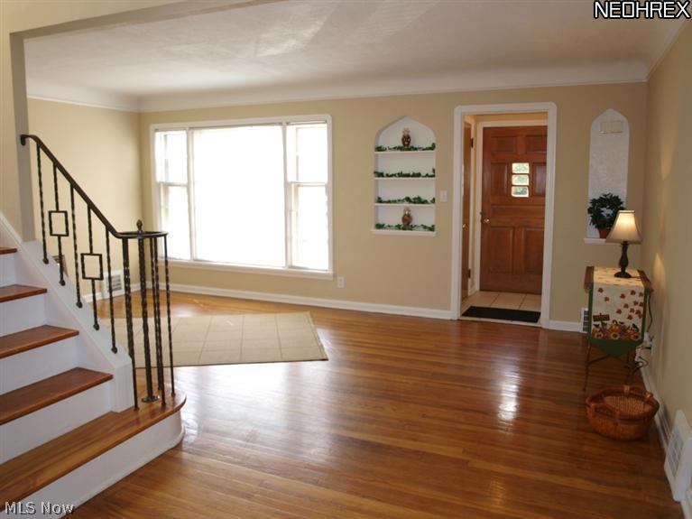 1577 Wood Road Cleveland, OH 44121 - Photo 4 of 25 Living Room with hardwood floor and large window to let plenty of natural light in.