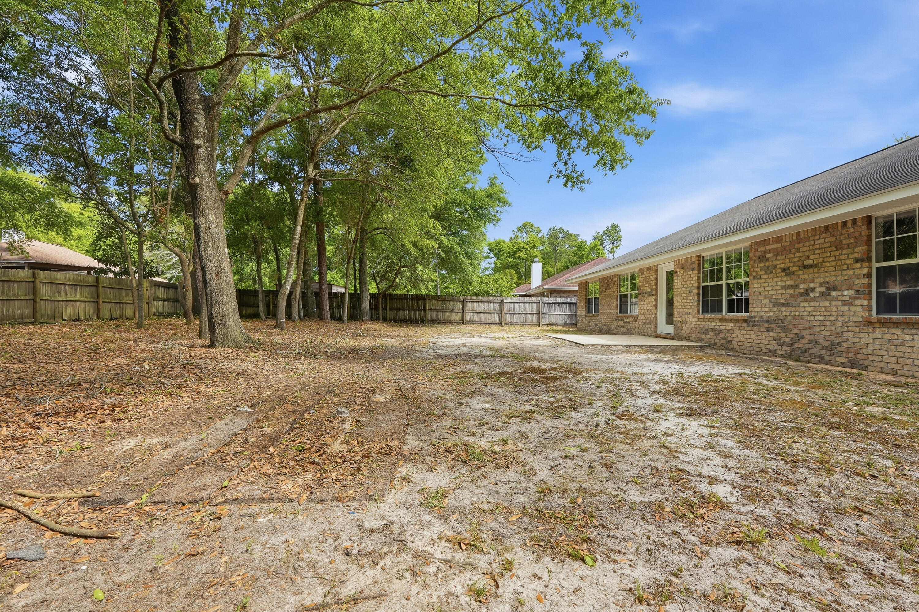 4087 Audiss Road Milton, FL 32583 - Photo 32 of 34 a backyard of a house with lots of green space