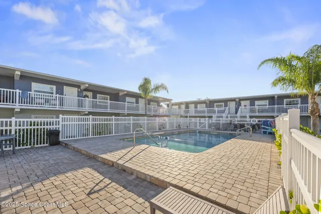 a view of swimming pool with outdoor seating and plants