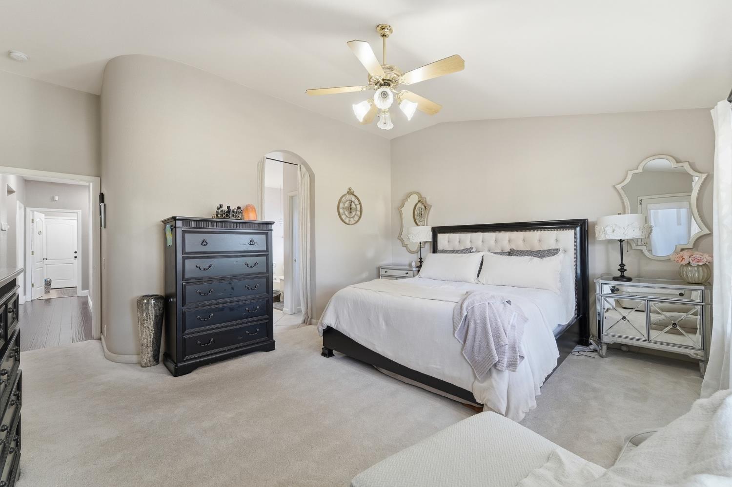 2220 Ellison Drive Modesto, CA 95355 - Photo 23 of 53 a bedroom with a bed and a chandelier