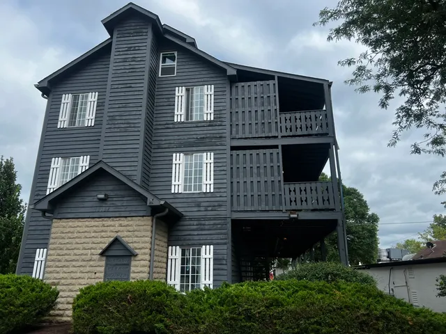 a front view of a house with plants and garage