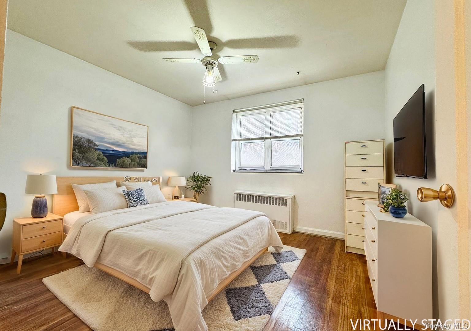 35-40 Clearview Expressway, Unit 371 Queens, NY 11361 - Photo 8 of 10 a bedroom with a bed and wooden floor