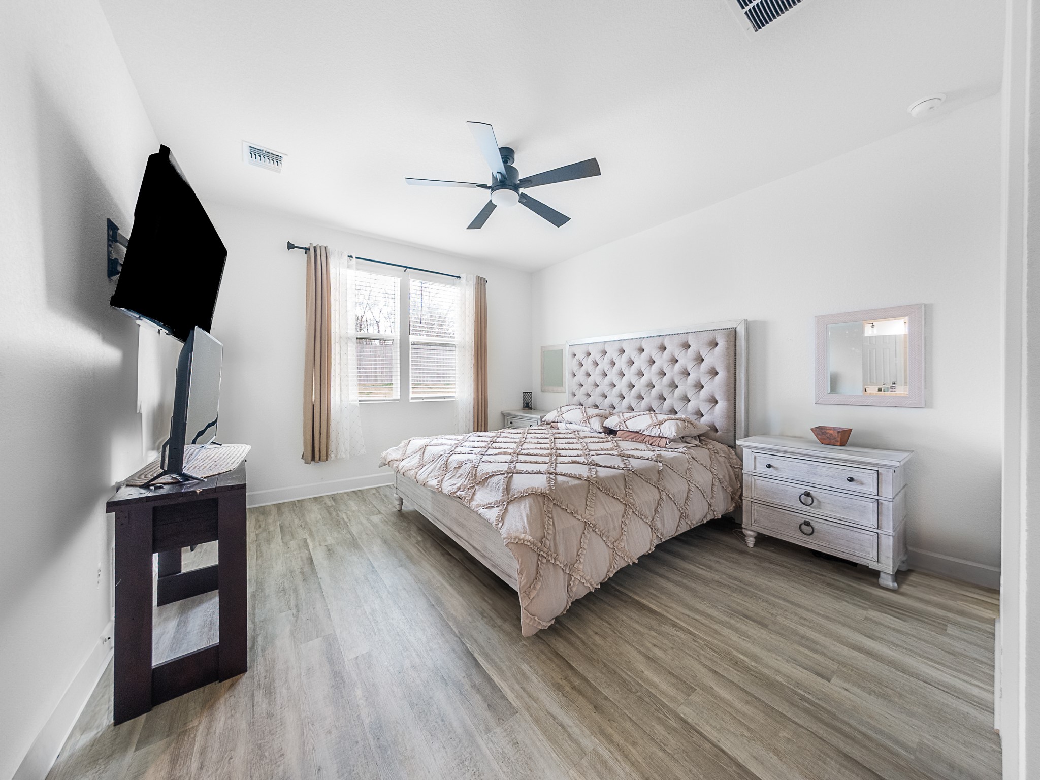 20811 Phebe Foster Street Manor, TX 78653 - Photo 17 of 40 Bedroom with light wood finished floors and ceiling fan