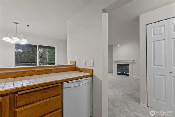 a view of a kitchen with a sink and dishwasher next to a window