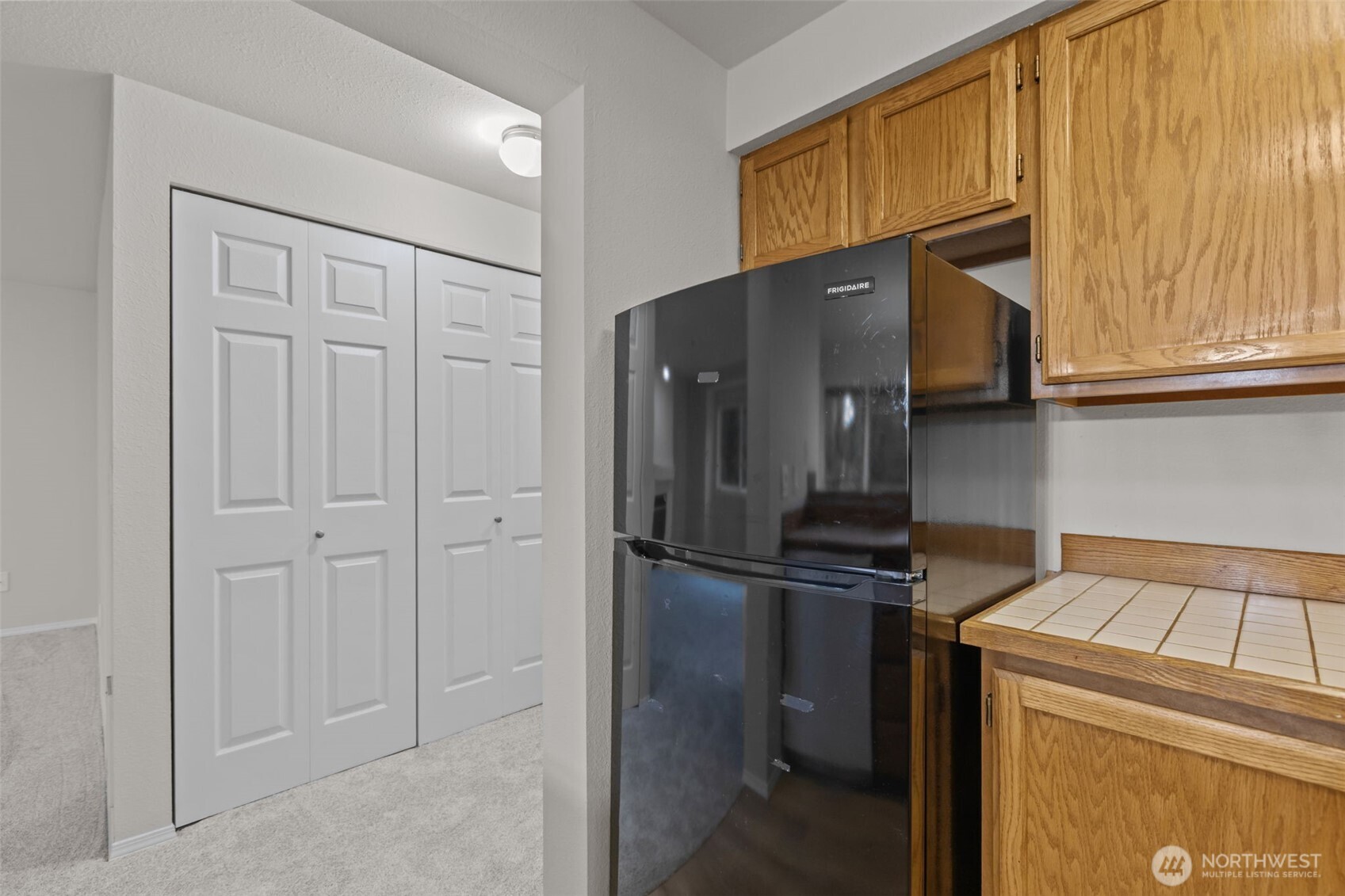 19404 Bothell Way Northeast, Unit B202 Bothell, WA 98011 - Photo 18 of 38 a kitchen with a refrigerator and cabinets