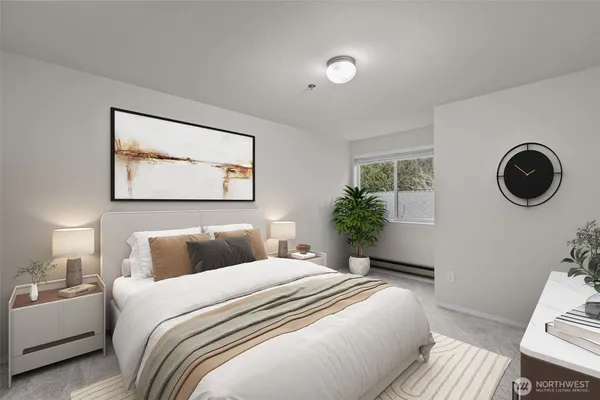 a bedroom with a bed and a lamp on dresser