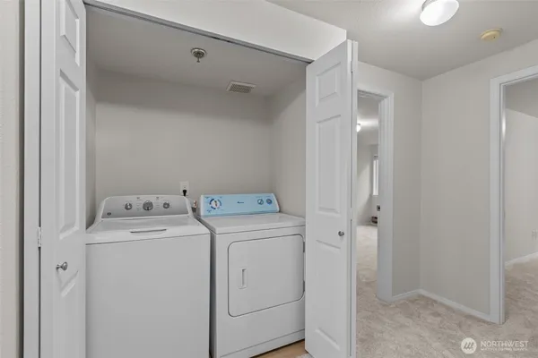 a view of storage and utility room with washer and dryer