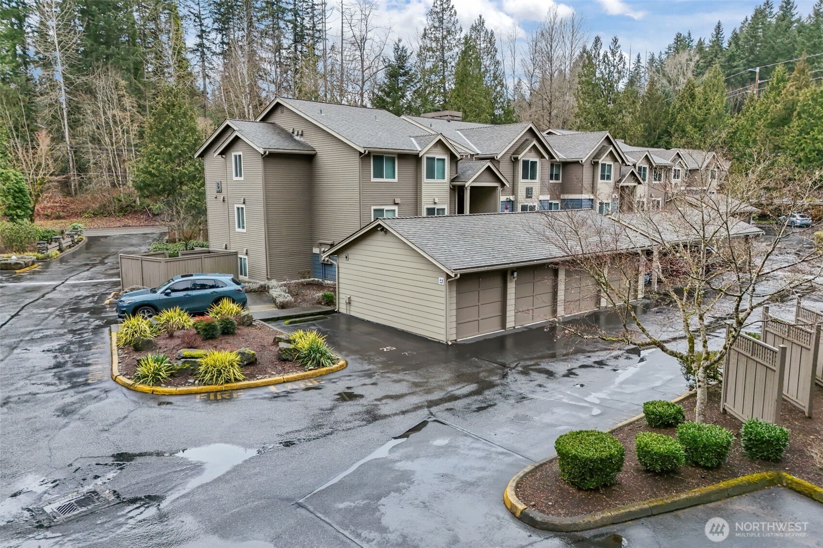 19404 Bothell Way Northeast, Unit B202 Bothell, WA 98011 - Photo 35 of 38 a view of a white house with a yard and potted plants