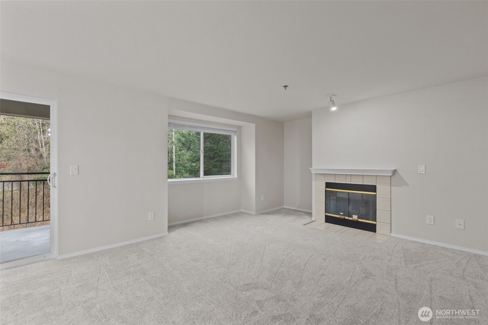 19404 Bothell Way Northeast, Unit B202 Bothell, WA 98011 - Photo 6 of 38 an empty room with a fireplace and windows