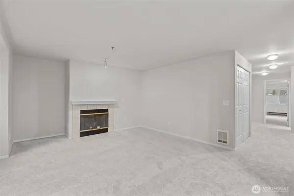 a view of empty room with a fireplace