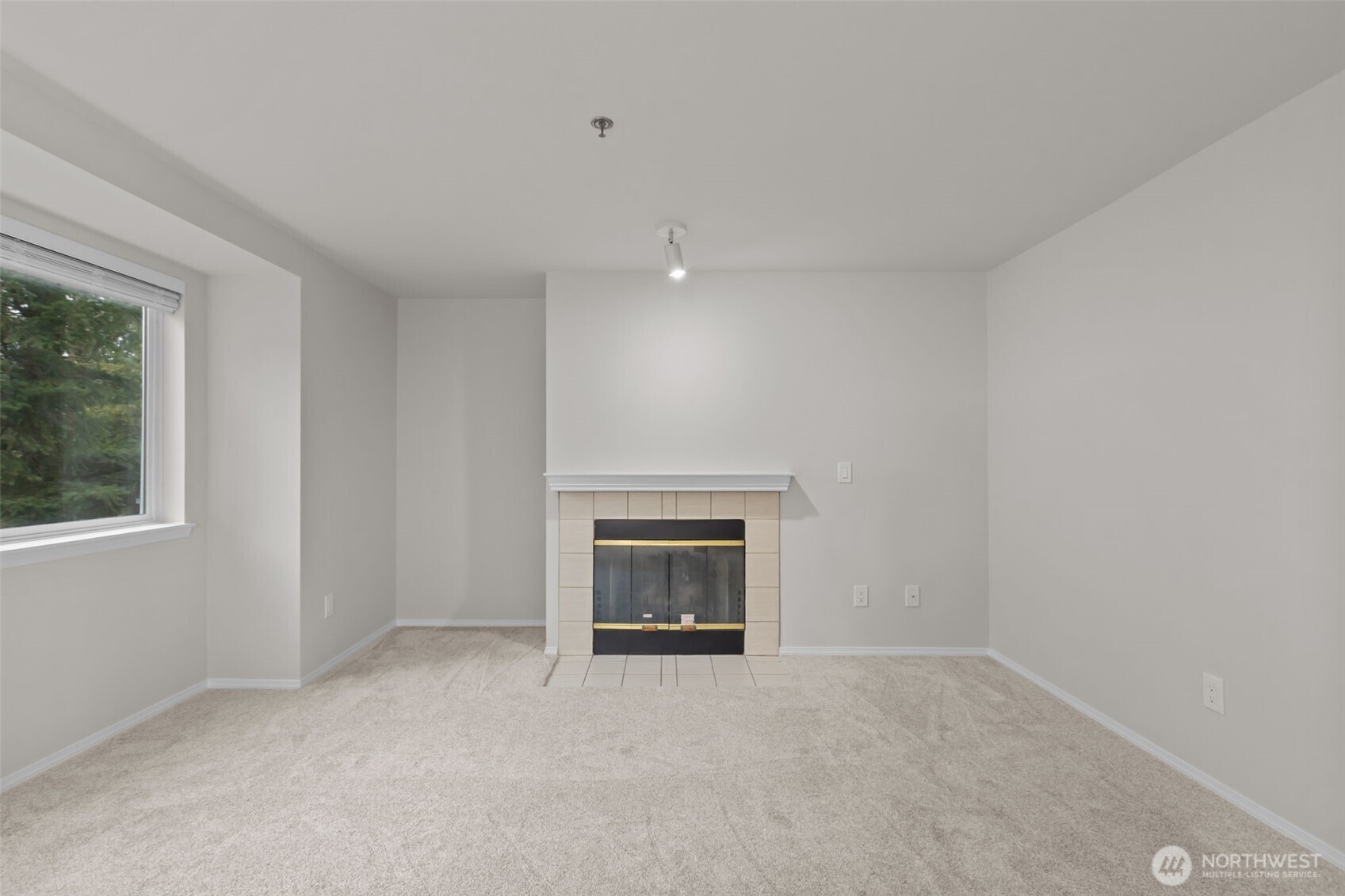 19404 Bothell Way Northeast, Unit B202 Bothell, WA 98011 - Photo 10 of 38 an empty room with a fireplace and window