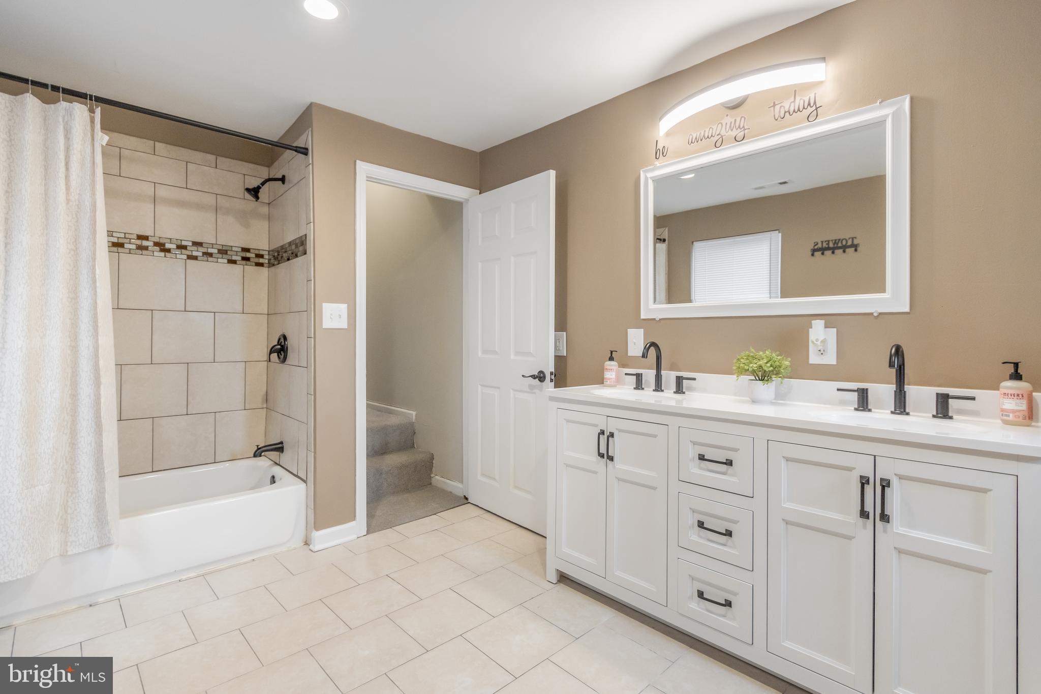 1235 North Bond Street Baltimore, MD 21213 - Photo 12 of 19 a spacious bathroom with a granite countertop sink mirror and shower