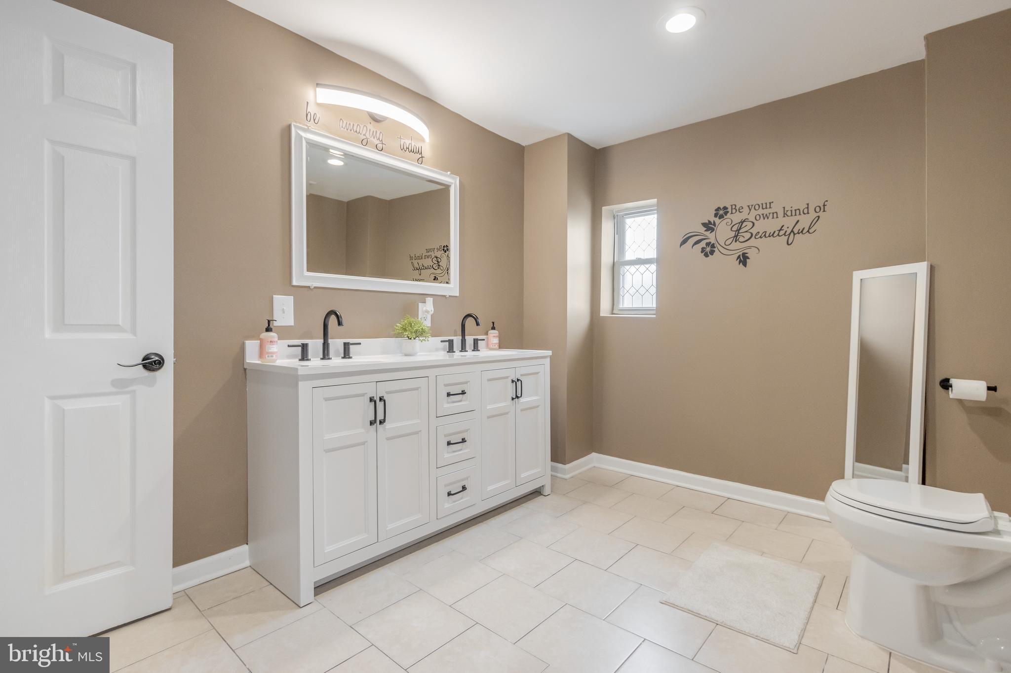 1235 North Bond Street Baltimore, MD 21213 - Photo 13 of 19 a bathroom with a double vanity sink mirror and bathtub