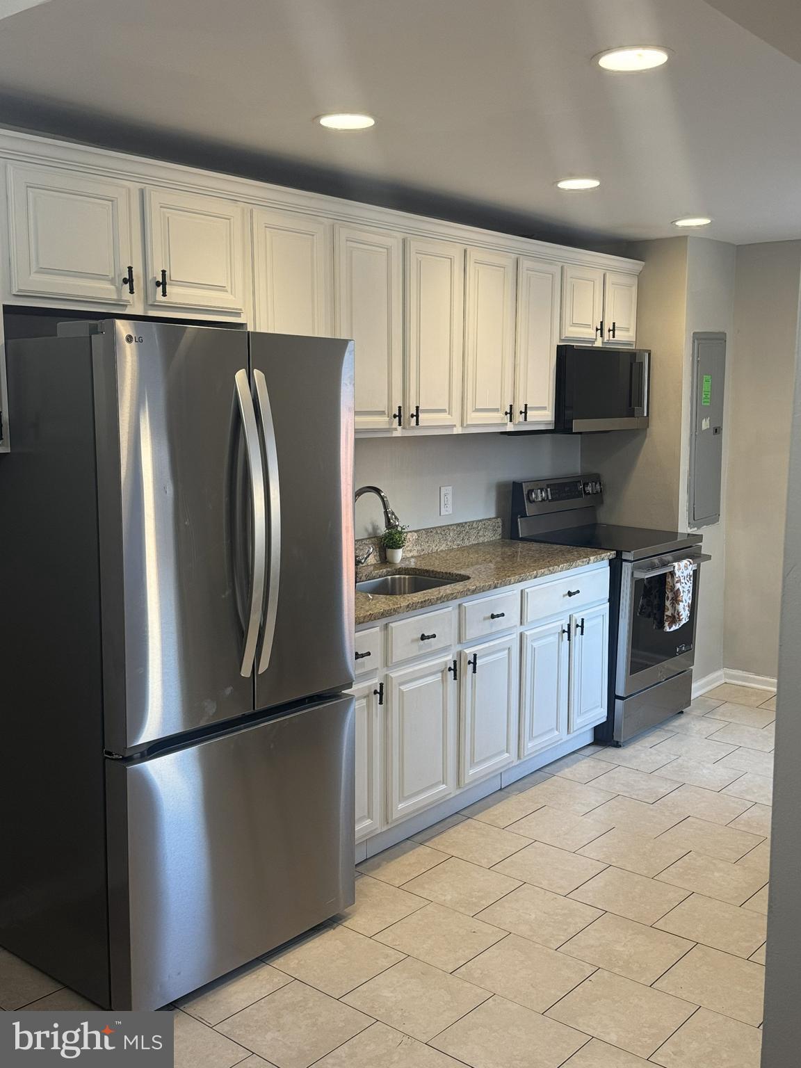 1235 North Bond Street Baltimore, MD 21213 - Photo 4 of 19 a kitchen with stainless steel appliances granite countertop a refrigerator sink and cabinets