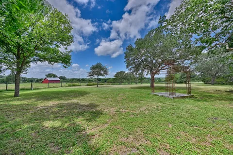 a backyard of a house with lots of green space