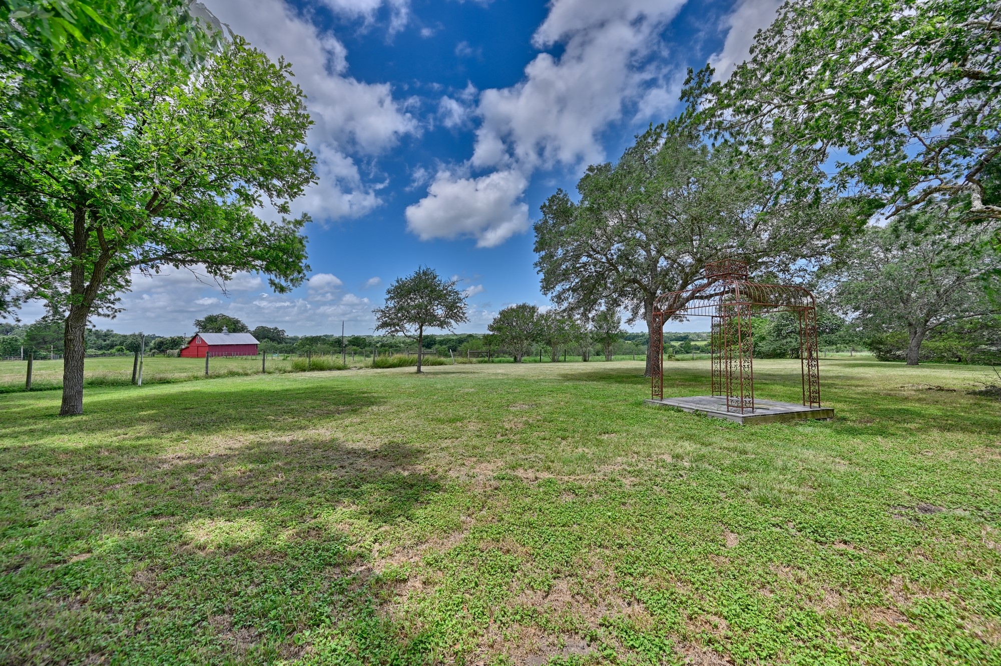 5208 Mensik Road Schulenburg, TX 78956 - Photo 12 of 18 a backyard of a house with lots of green space