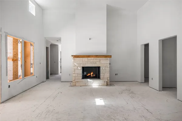 a view of a livingroom with a fireplace and window