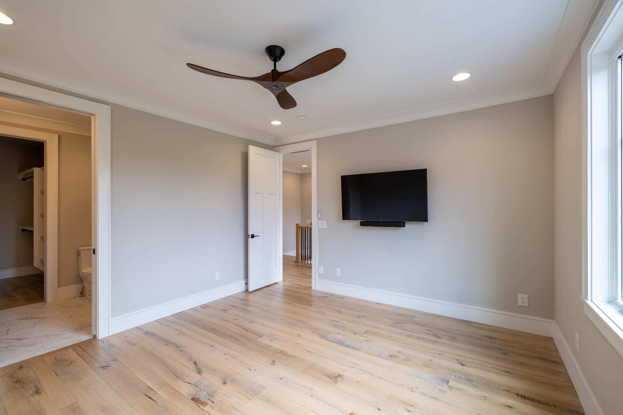 1442 Coleman Road Franklin, TN 37064 - Photo 44 of 63 a view of a livingroom with a flat screen tv wooden floor and a ceiling fan