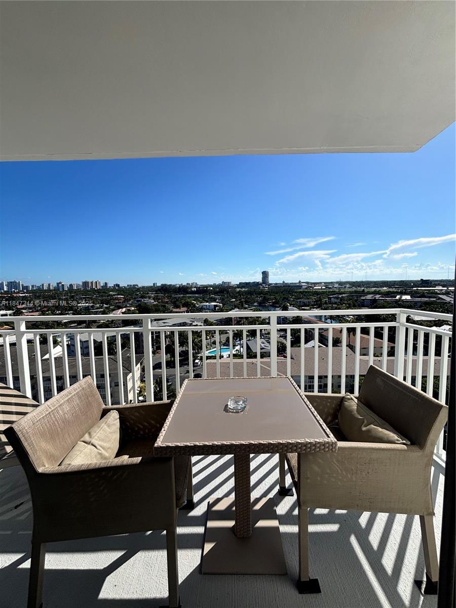 427 Golden Isles Drive, Unit 12B Hallandale Beach, FL 33009 - Photo 5 of 10 a view of a chairs and table on the roof deck