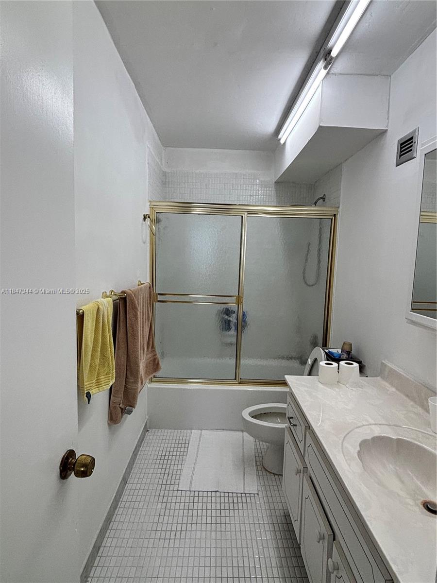 427 Golden Isles Drive, Unit 12B Hallandale Beach, FL 33009 - Photo 9 of 10 a bathroom with a sink and mirror