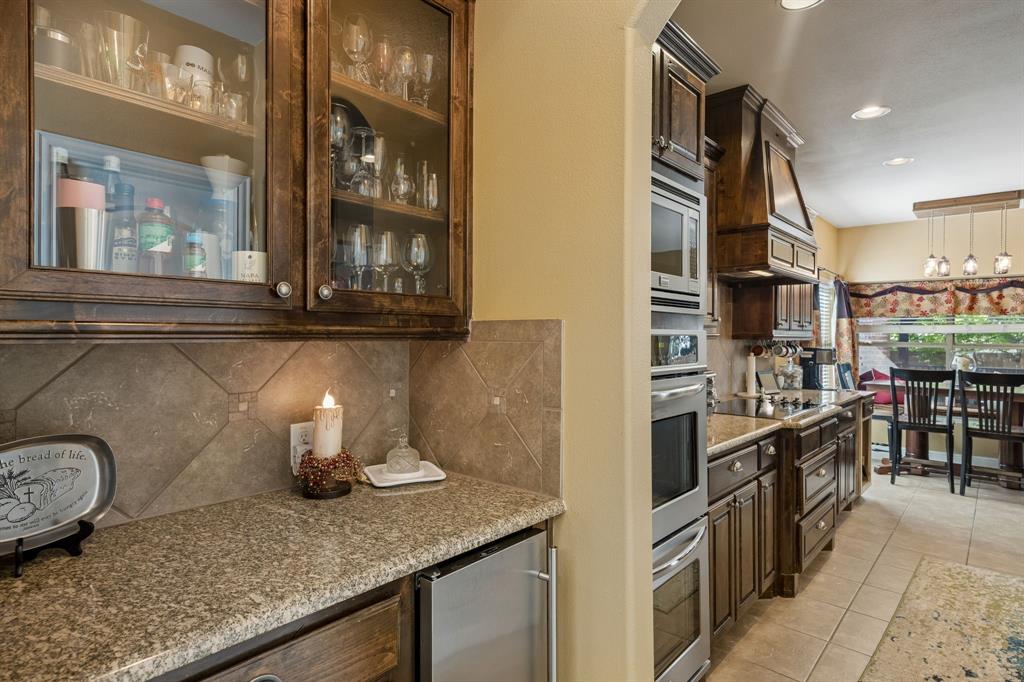 8104 Red Riv Run North Richland Hills, TX 76180 - Photo 7 of 38 a kitchen with stainless steel appliances granite countertop a sink and a stove